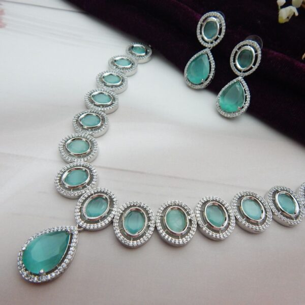 A designer choker necklace and earring set featuring a floral cluster design and a silver finish.