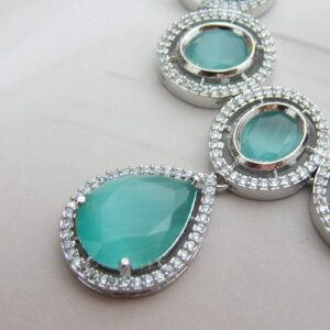 A designer choker necklace and earring set featuring a floral cluster design and a silver finish.