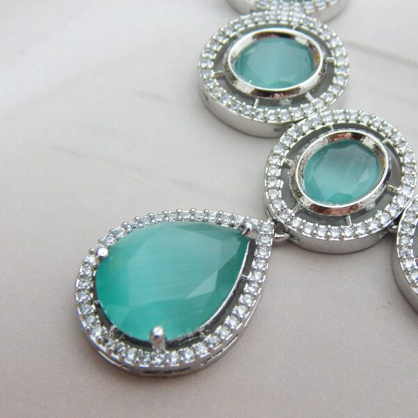 A designer choker necklace and earring set featuring a floral cluster design and a silver finish.