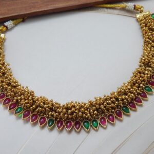 Guttapusalu necklace in Multi color — ruby red and green teardrop stones on gold bead base