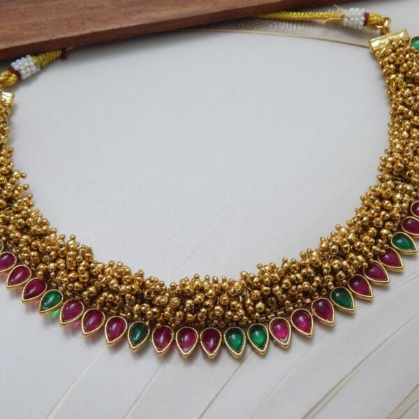 Guttapusalu necklace in Multi color — ruby red and green teardrop stones on gold bead base