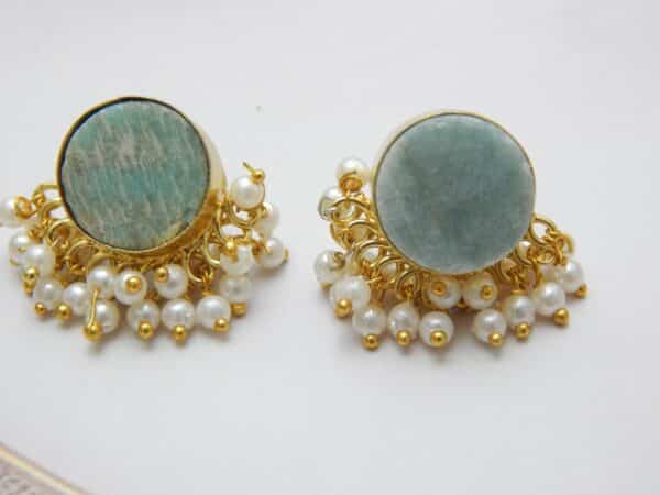 Gold-tone stud earrings with a round, teal/aqua Amazonite stone and a border of dangling white pearl clusters.