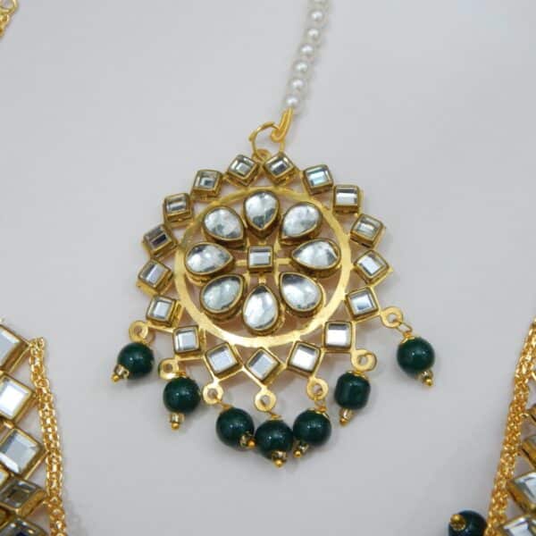 Navratri Green Jewellery - Royal Reflection DS A Kundan maang tikka and matching earrings set with large fan-shaped pendants and dark green beaded drops.