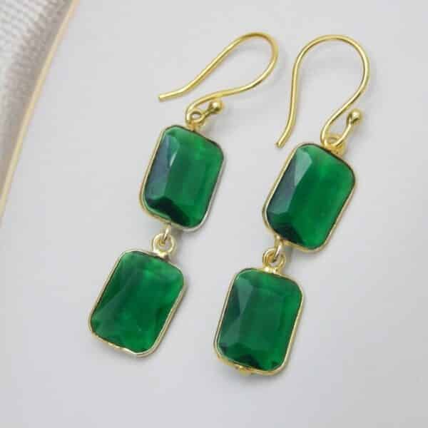 Navratri Green Jewellery - Royal Reflection DS Gold-tone dangle earrings with two rectangular, faceted colored green stones stacked vertically.