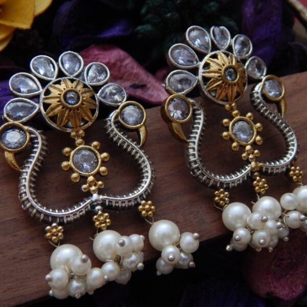 Navratri White Jewellery - Royal Reflection DS A pair of dual-tone oxidized silver and gold earrings with white Kundan-style stones and large pearl cluster dangles.