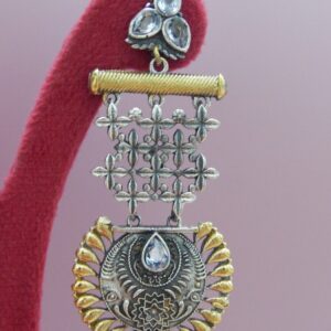 A pair of large, dual-tone oxidized silver and gold earrings with jaali lattice work and a scalloped medallion dangle.