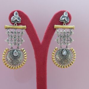 A pair of large, dual-tone oxidized silver and gold earrings with jaali lattice work and a scalloped medallion dangle.