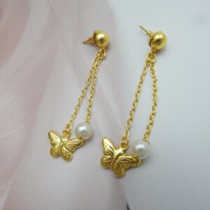 A pair of gold-tone ball stud earrings with a chain drop featuring a butterfly charm and a white pearl.