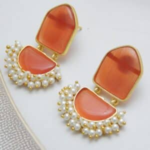 Pearl cluster dangler earrings with orange geometric stone and half-moon drop