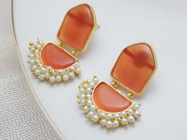 Pearl cluster dangler earrings with orange geometric stone and half-moon drop