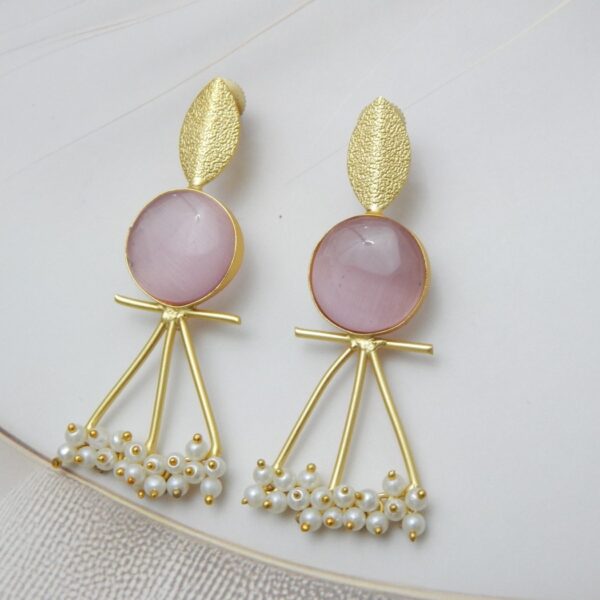 A pair of gold-tone artistic earrings with a leaf stud, a large round pink stone, and a cluster of pearl dangles.