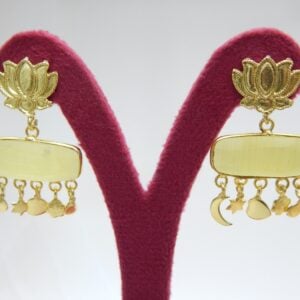 A pair of polished gold-tone earrings with a lotus stud and a horizontal, rectangular yellow stone dangle.