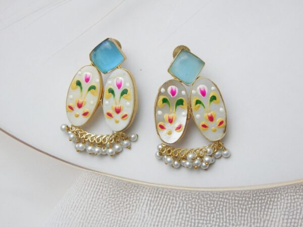 Gold-tone fusion earrings with a geometric stone stud, patterned floral ovals (mother-of-pearl look), and white pearl dangles.