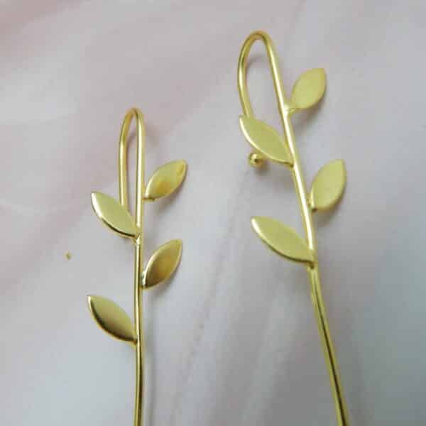 Gold-tone minimalist leaf earrings with four leaves along a slim bar and hook ear wire