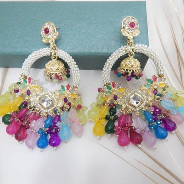 A pair of gold Kundan jhumka earrings with a half-moon design and a variety of colorful beaded drops.