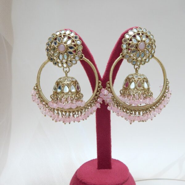 Navratri Purple Jewellery - Royal Reflection DS A pair of large, traditional hoop jhumka earrings with intricate mirror work on the top stud and bell, and a cluster of dangling pink colored beads on the bottom.
