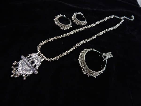 Complete German Silver tribal jewelry set: Long ghungroo beaded necklace with elephant pendant and two pairs of matching oxidized jhumka hoops.