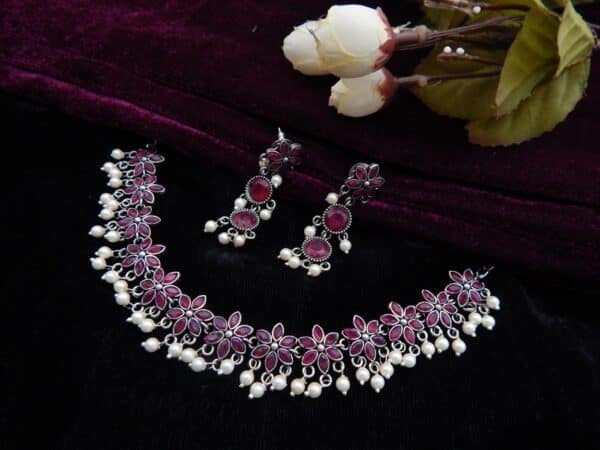 Oxidised floral choker set with pearl drops and matching earrings in dark pink