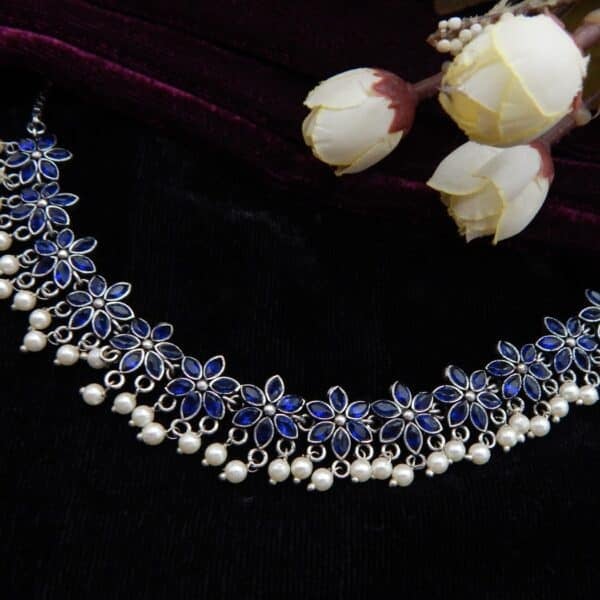 Navratri Royal Blue Jewellery - Royal Reflection DS German Silver choker necklace with blue stone floral links and white faux pearl drops