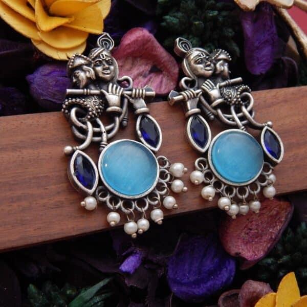 Radha Krishna dangler earrings in oxidised finish with aqua cat eye stone