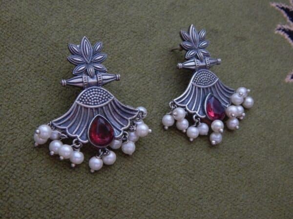 Oxidised lotus drop earrings in ruby red with pearl fringe