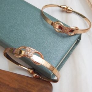 Timeless Chic Rose Gold Bangle with Floral Engraving and Crystal Bow Accents – Royal Reflection DS