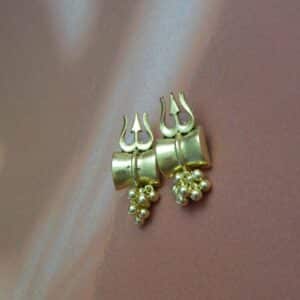 A pair of small, antique gold-toned earrings with a Trishul (trident) design and a cluster of gold beads hanging below