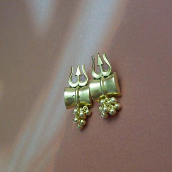 A pair of small, antique gold-toned earrings with a Trishul (trident) design and a cluster of gold beads hanging below
