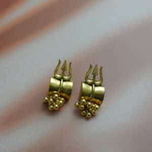 A pair of small, antique gold-toned earrings with a Trishul (trident) design and a cluster of gold beads hanging below