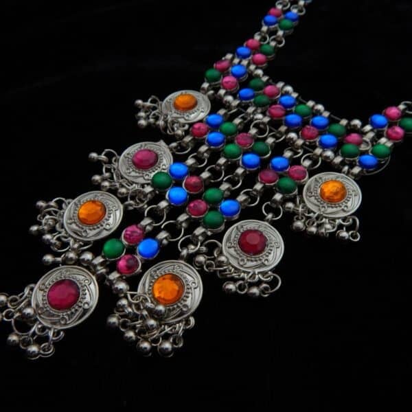 zoom of Heavy tribal German Silver necklace featuring cascading medallions, bright pink, blue, green, and orange beads, and ghungroo bells.