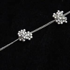 zoom of Delicate silver tone Y-shaped lariat necklace with floral bead clusters descending along the drop.