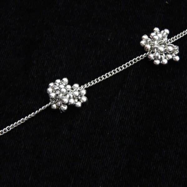 zoom of Delicate silver tone Y-shaped lariat necklace with floral bead clusters descending along the drop.