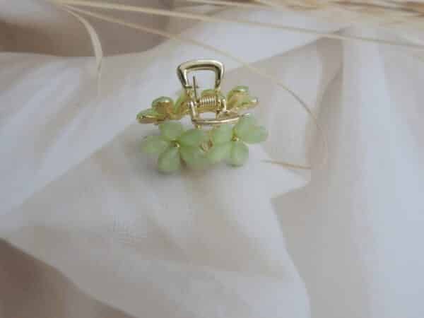 front view of Small gold-toned hair claw clip with a cluster of mint green faceted floral stones, elegant hair accessory for women.