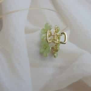 top view of Small gold-toned hair claw clip with a cluster of mint green faceted floral stones, elegant hair accessory for women.