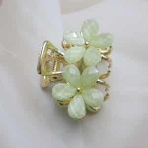 vertical view of Small gold-toned hair claw clip with a cluster of mint green faceted floral stones, elegant hair accessory for women.