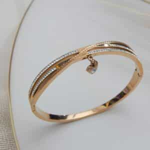 Rose gold triple-line crystal kada with dangling stone charm – Ishya Charm Kada.