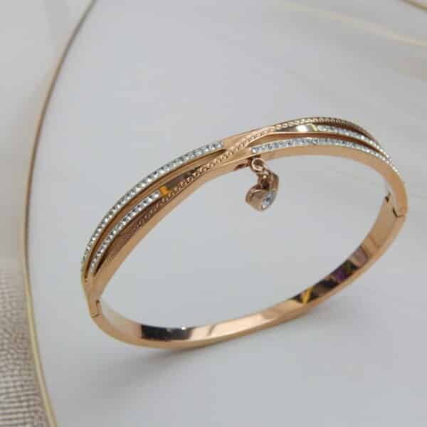 Rose gold triple-line crystal kada with dangling stone charm – Ishya Charm Kada.