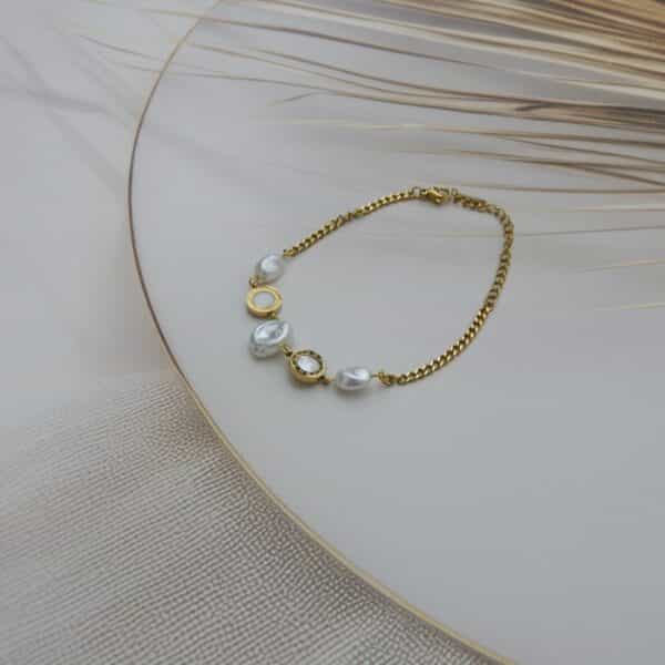 Full view of pearl and Roman charm gold bracelet on display – Royal Reflection Dazzling Studio