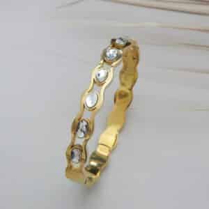 Gold wavy kada with round crystal stones – Tarini Crystal Wave Kada.