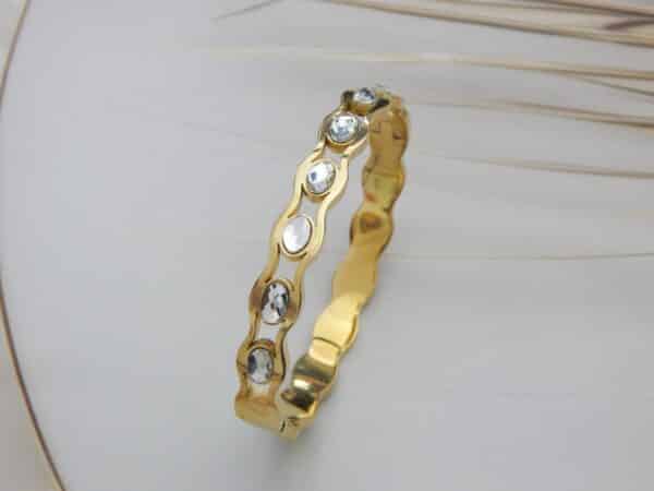 Gold wavy kada with round crystal stones – Tarini Crystal Wave Kada.