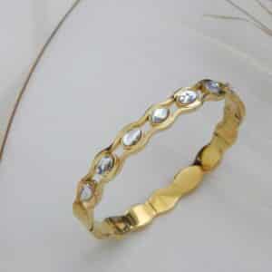 Side view of gold-plated stone-studded wave bracelet – Royal Reflection Dazzling Studio.