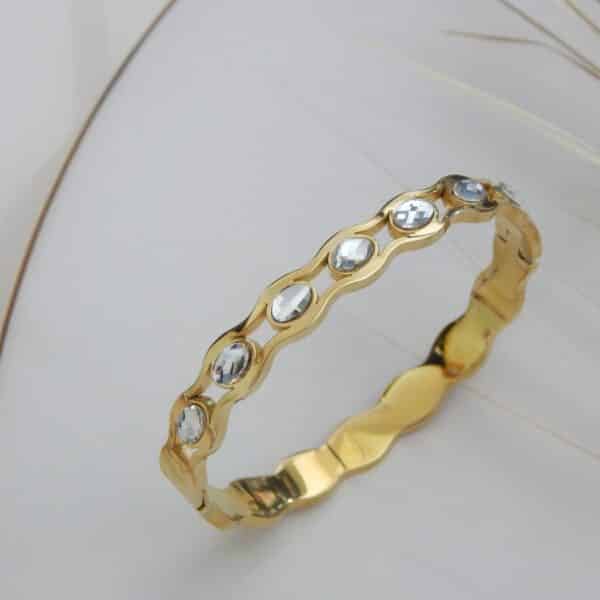 Side view of gold-plated stone-studded wave bracelet – Royal Reflection Dazzling Studio.