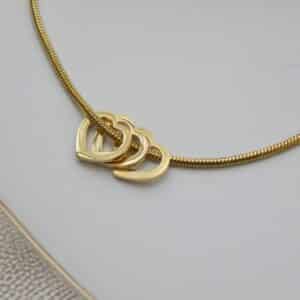 Close-up of gold snake chain bracelet with interlocked heart design – Royal Reflection Dazzling Studio