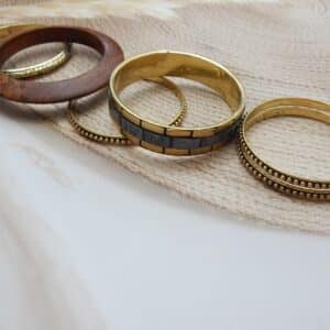 Antique gold and wood-finish stacked bangles set with beaded and embossed detailing – Aaravi Stacked Bangles Set.