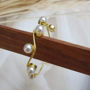 Gold-plated wavy design kada with round pearl accents – Aarika Wave Pearl Kada.