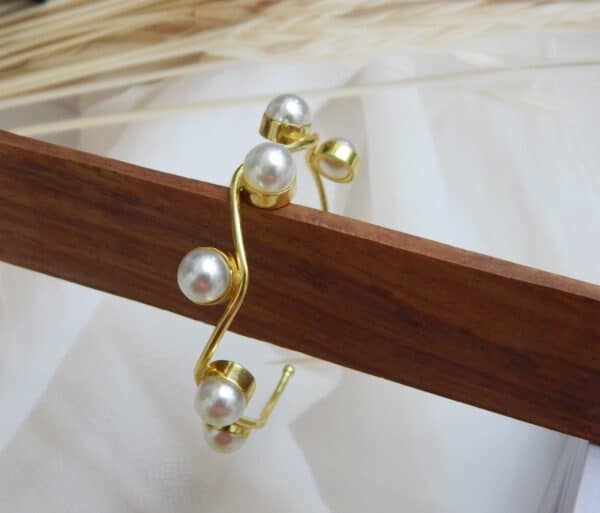 Gold-plated wavy design kada with round pearl accents – Aarika Wave Pearl Kada.