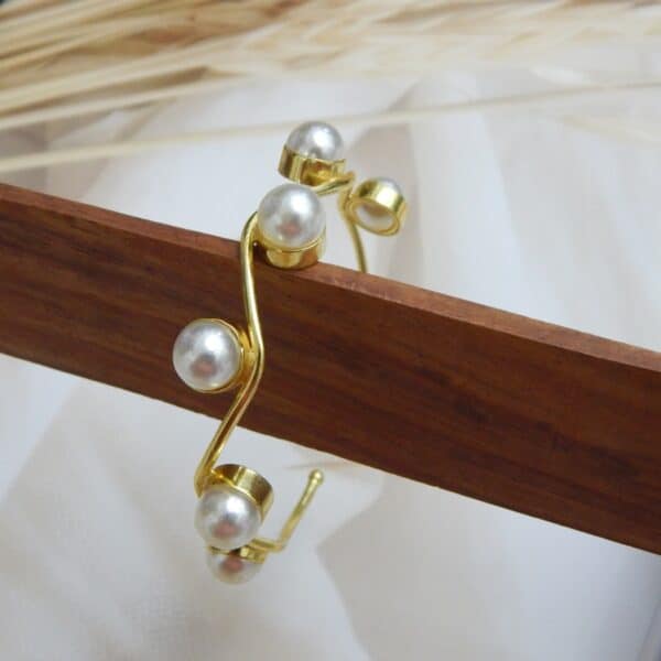 Gold-plated wavy design kada with round pearl accents – Aarika Wave Pearl Kada.