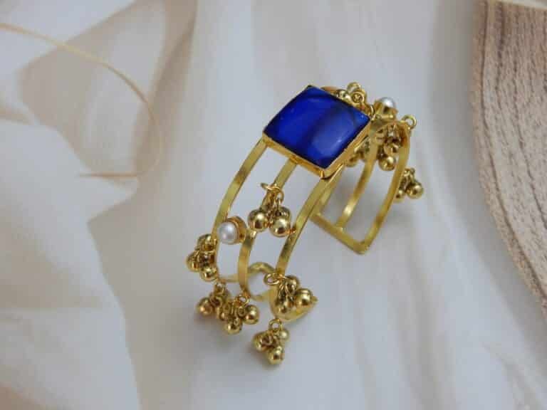 Gold-plated kada with square blue stone and ghungroo charm detailing – Rishika Ghungroo Kada.