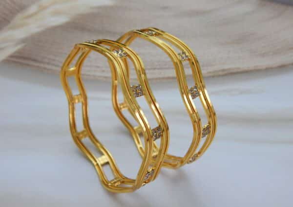 Gold-plated wave design bangle with CZ stone clusters – Zayana Wave CZ Bangle.