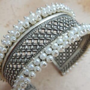 Close-up of oxidised silver jali cuff bracelet showing pearl bead border and lattice pattern detail